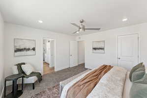 Spacious bedroom featuring neutral wall tones, recessed lighting, a ceiling fan, and soft carpet flooring