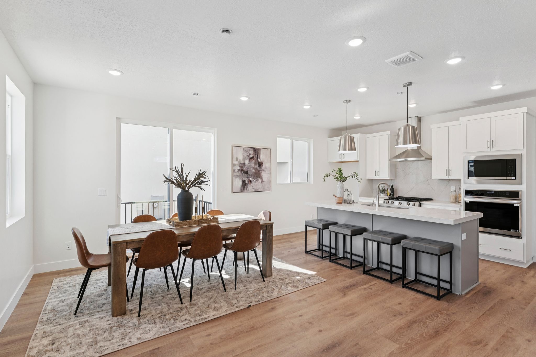 Open-concept living space featuring wood-finish flooring, recessed lighting, and a modern kitchen