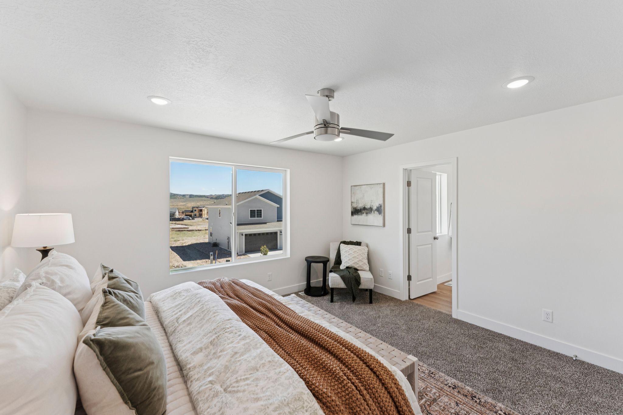 Bedroom featuring a large picture window, recessed lighting, and a ceiling fan with light
