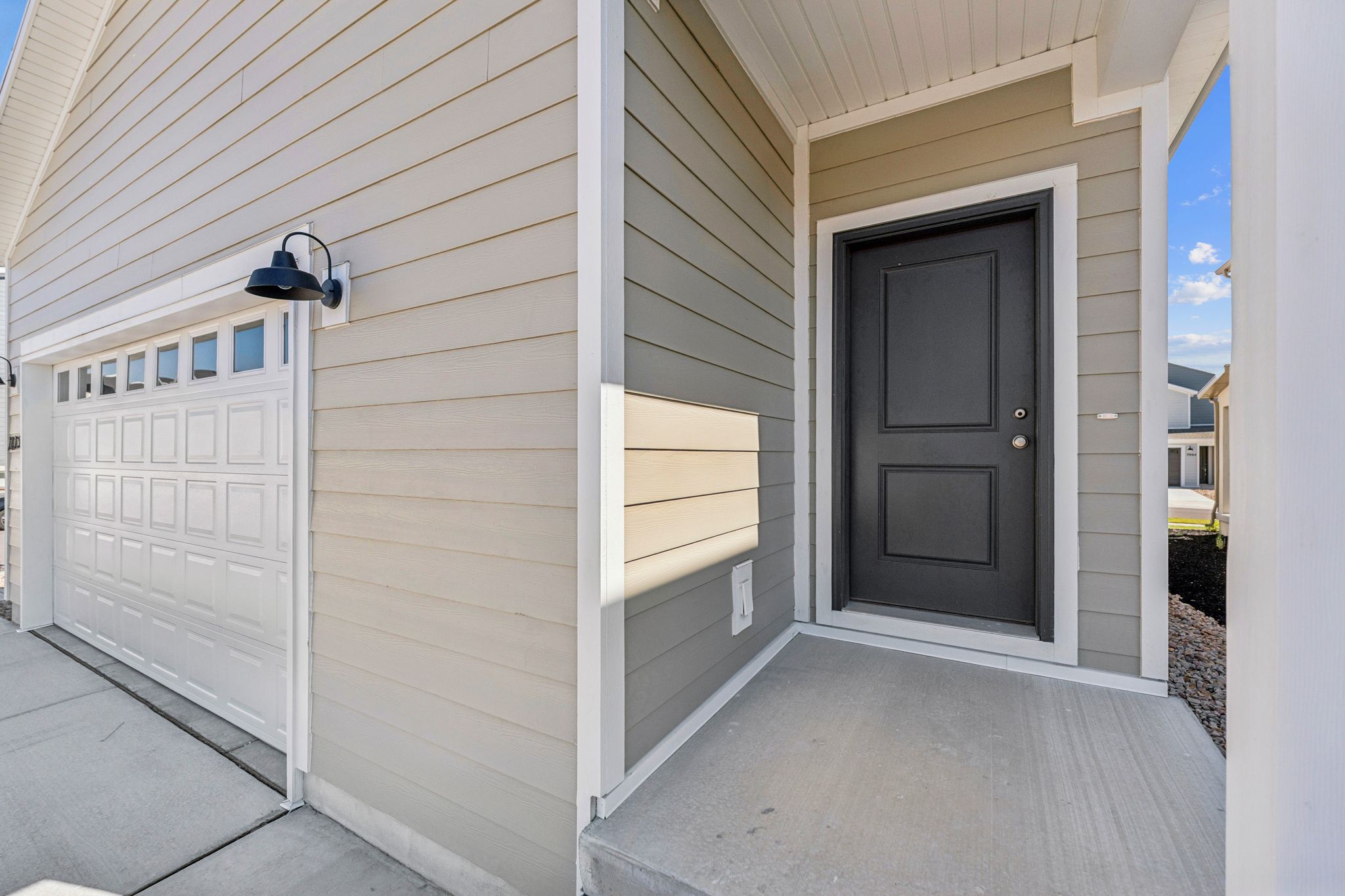 Entryway featuring a dark paneled door and concrete porch