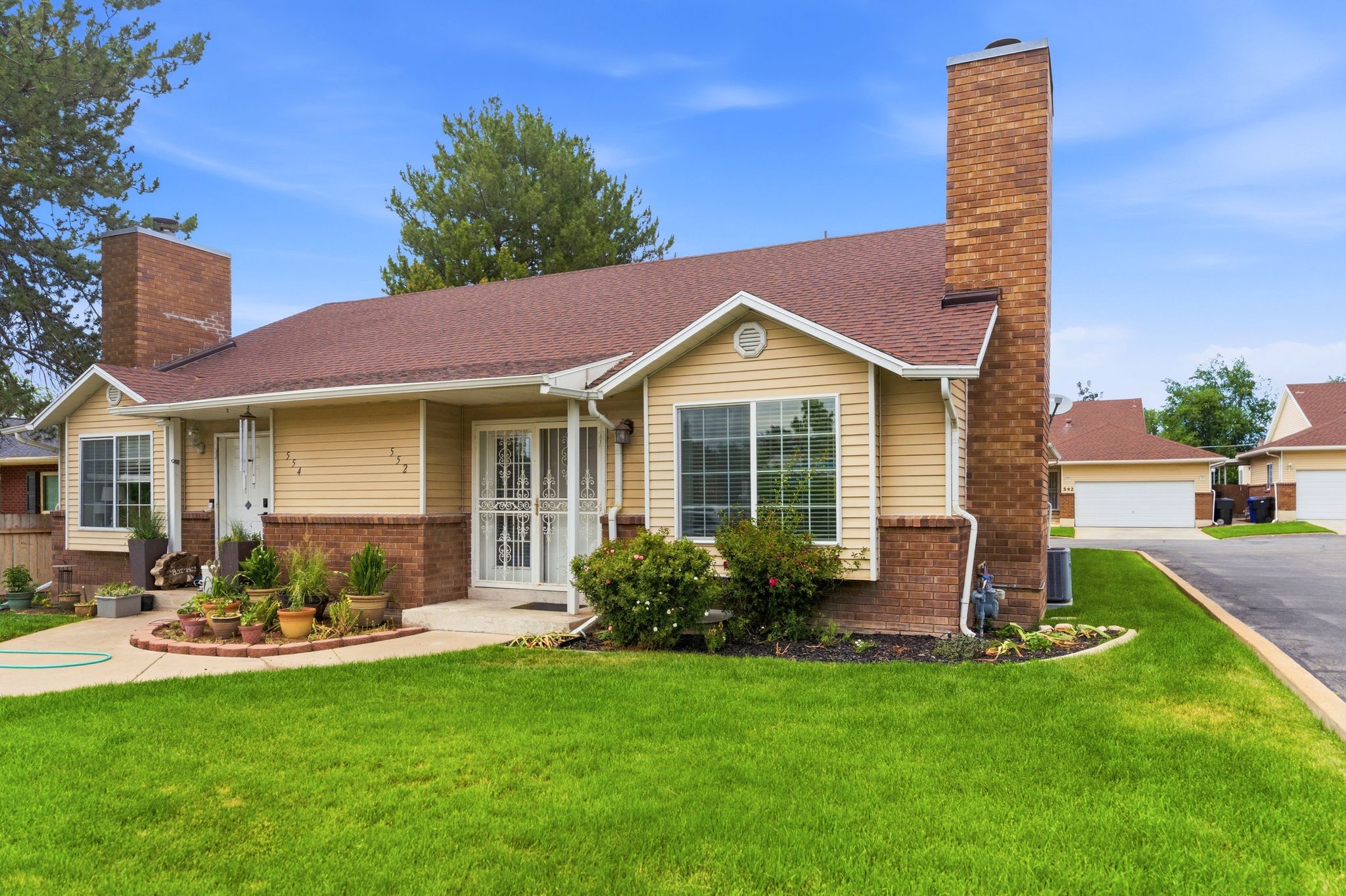 Exterior facade with light-colored siding and brick accents