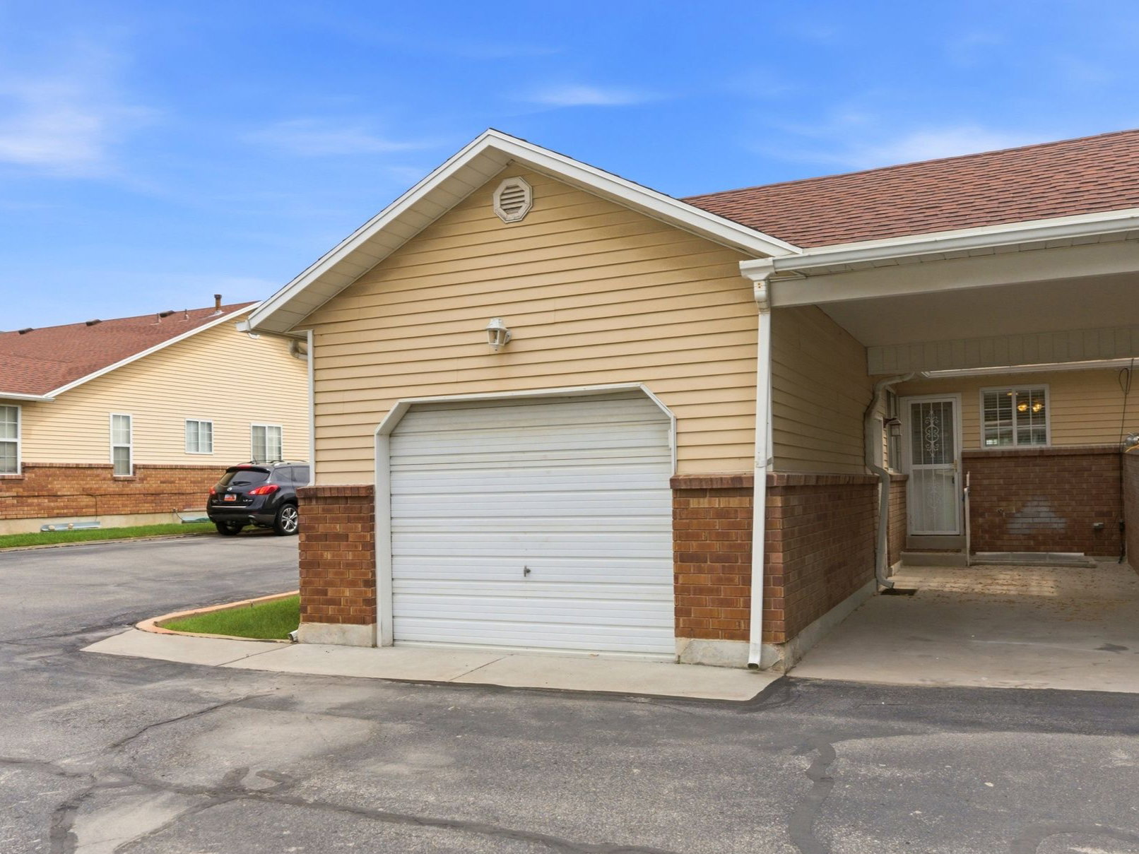 Attached single-car garage and a covered carport area