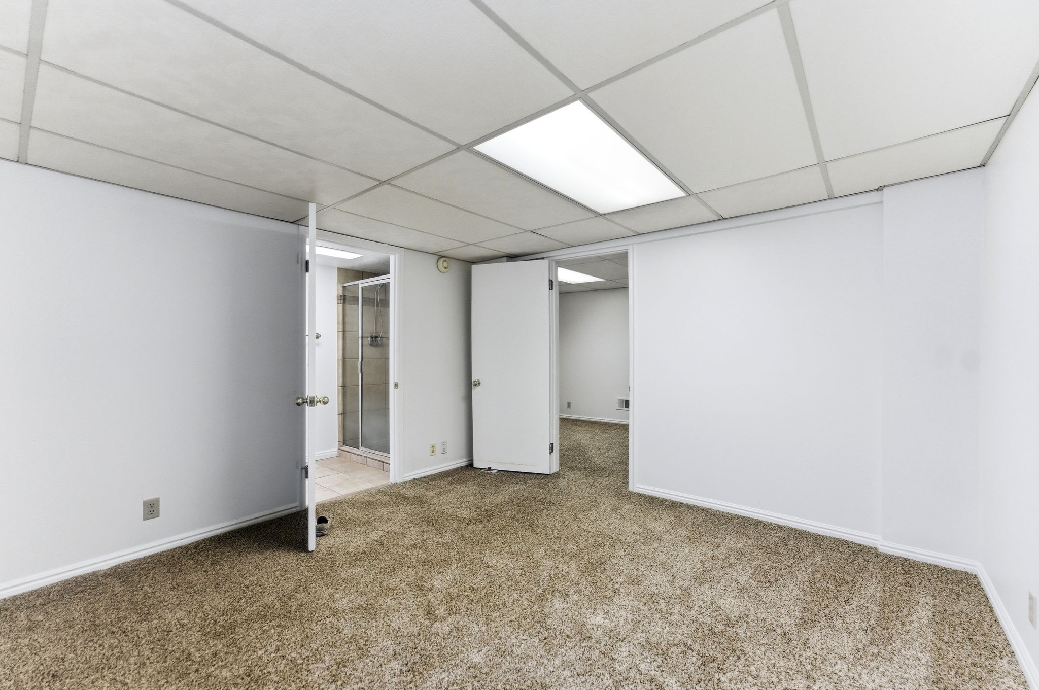 Room featuring neutral-toned carpet flooring and white painted walls