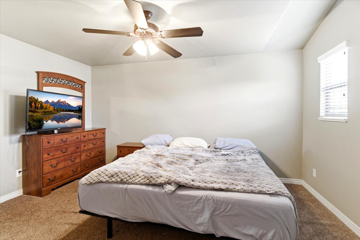 Bedroom featuring neutral-toned walls and plush carpet flooring