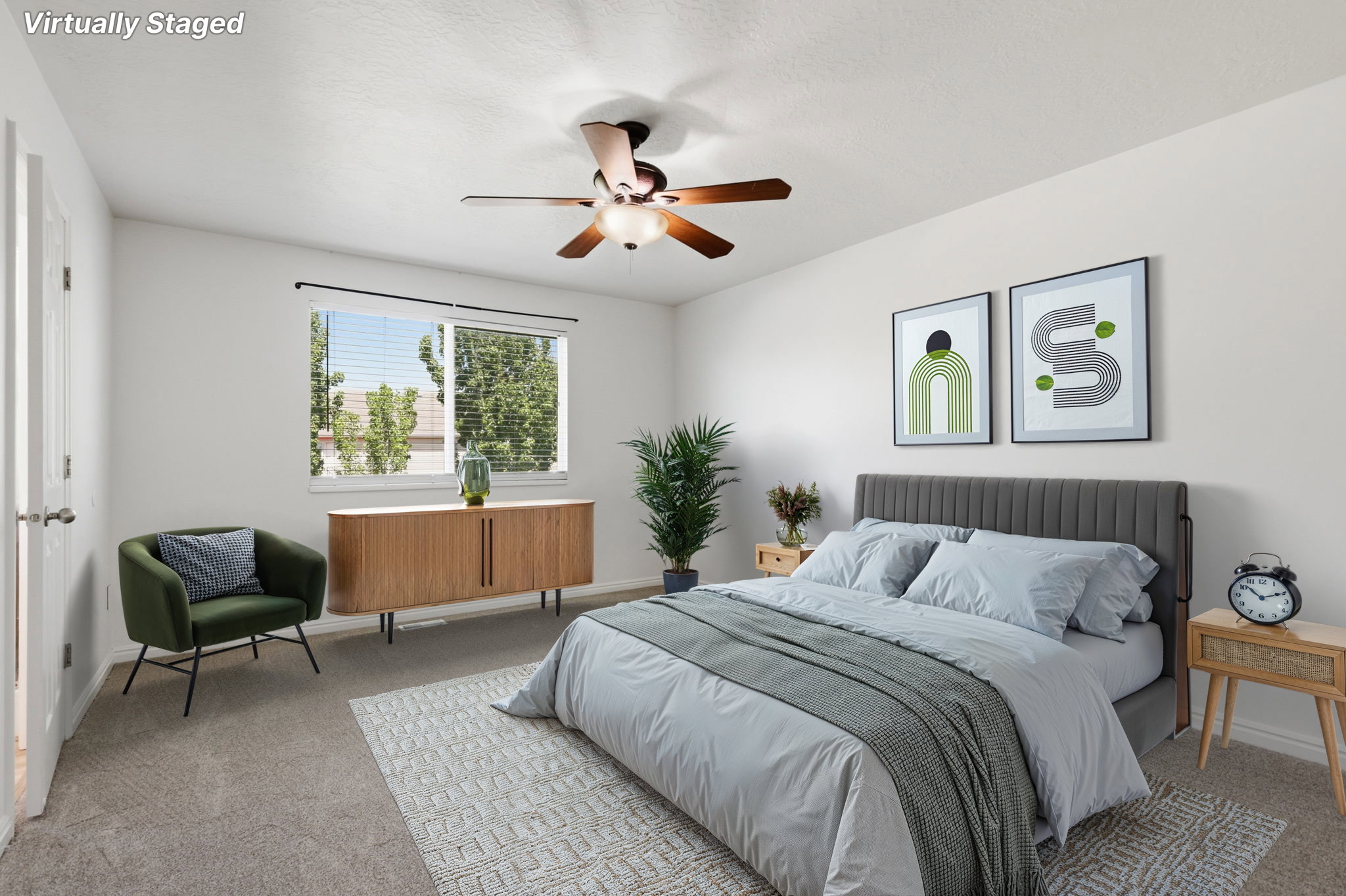 Carpeted bedroom with a ceiling fan light fixture and dual windows featuring blinds