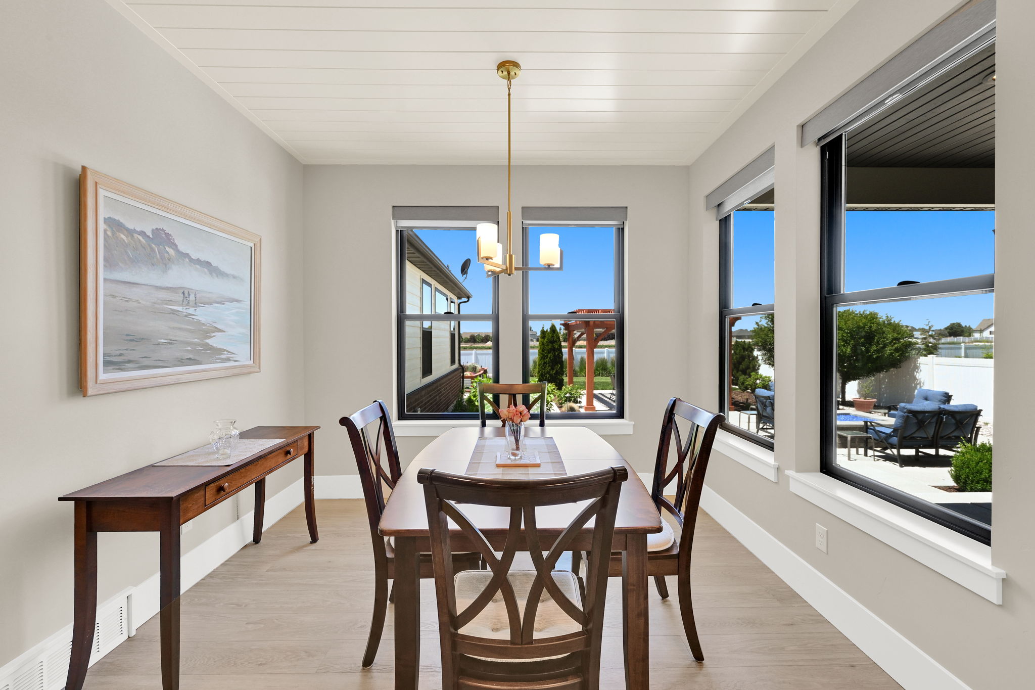 Dining space featuring light wood-finish flooring, a shiplap ceiling, and multiple windows