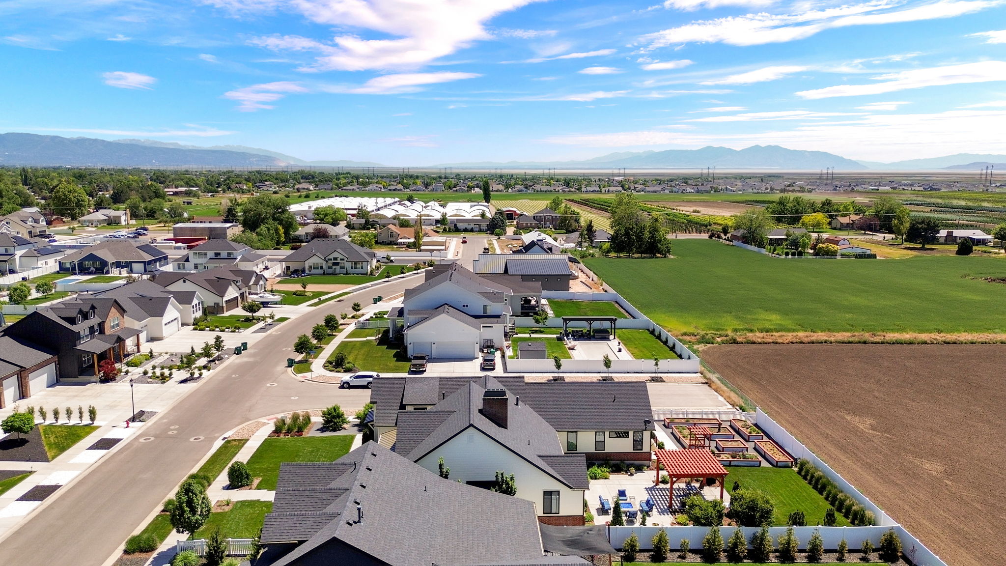 Residential neighborhood featuring modern architecture, manicured landscaping, and mountain scenery