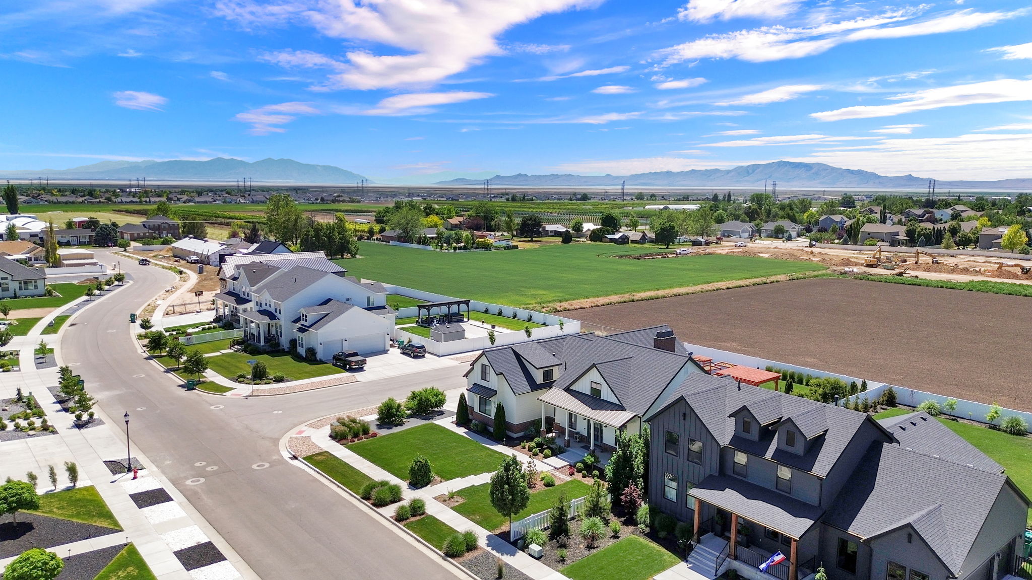 Aerial perspective highlighting a modern residential neighborhood with a curved street