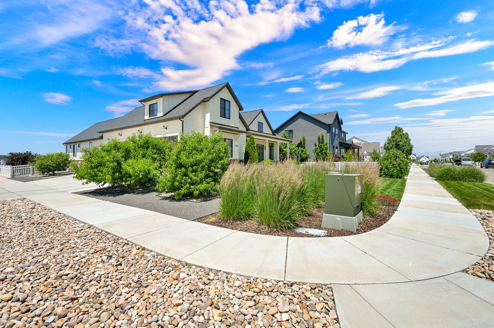 Contemporary-style residence with a light-colored exterior and dark-gray roof