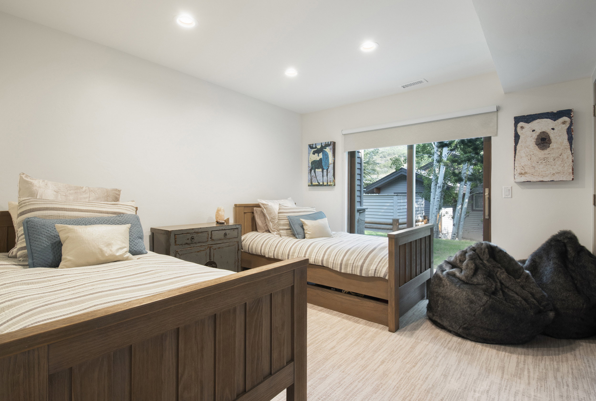 Expansive room featuring wood-finish flooring, recessed lighting, and a sliding glass door providing direct outdoor access