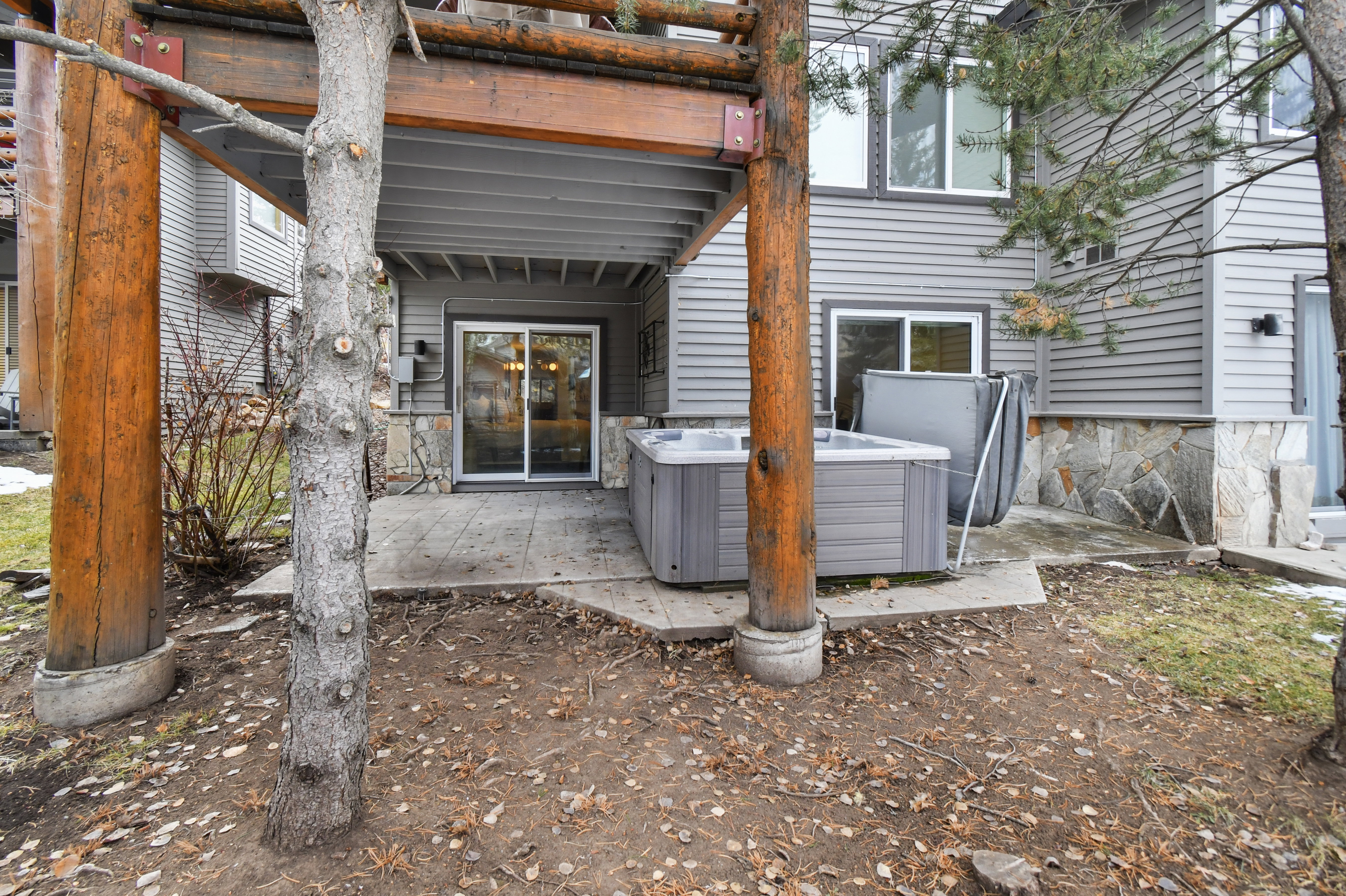 Private patio featuring a hot tub, concrete paving, and a sliding glass door entry