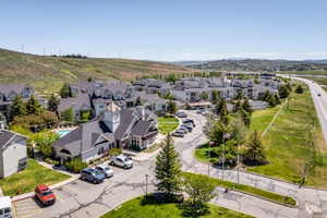 Expansive property featuring multiple residential buildings, a central clubhouse with a clock tower, and an outdoor swimming pool
