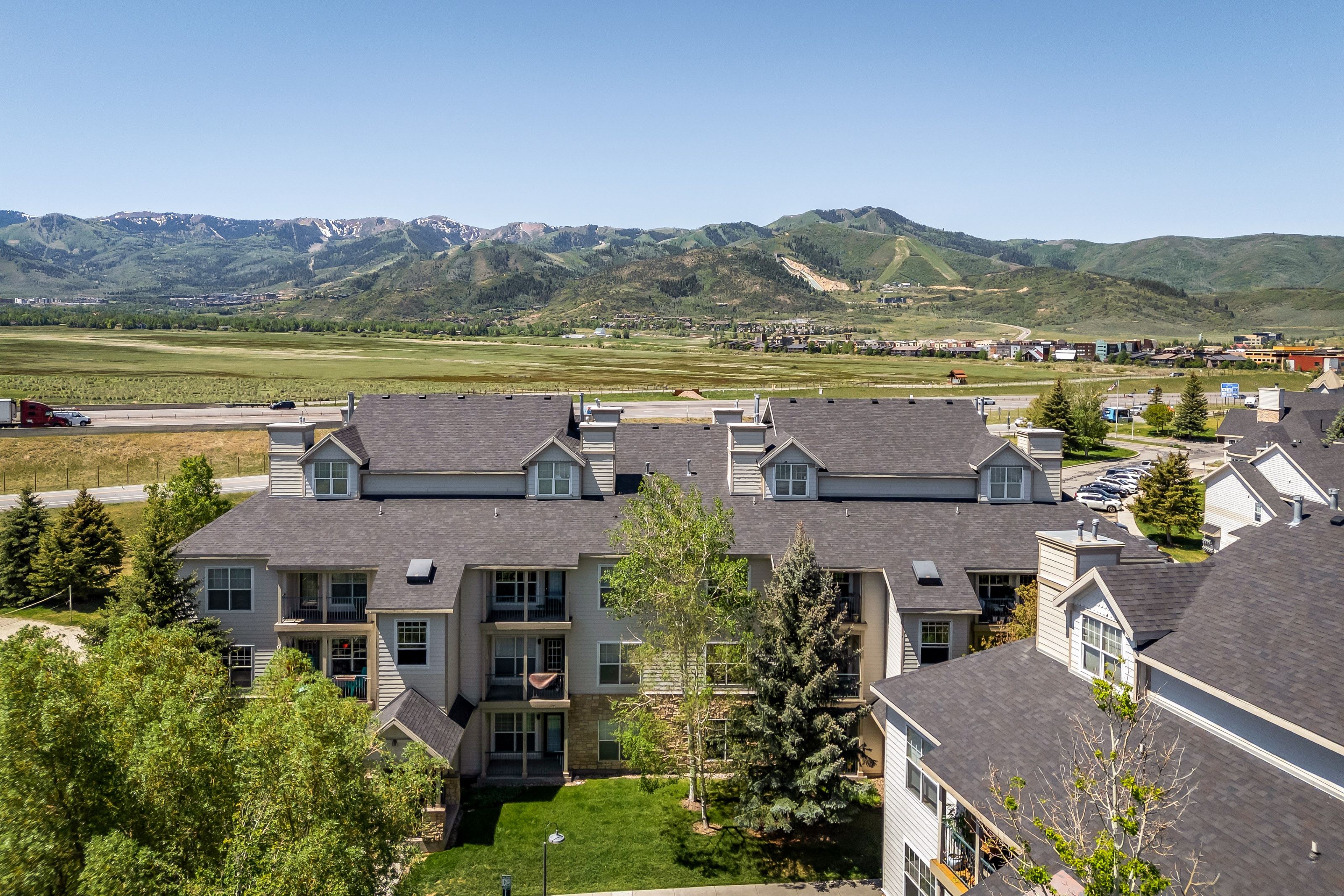 Multi-story residential complex featuring multiple balconies and dormer windows