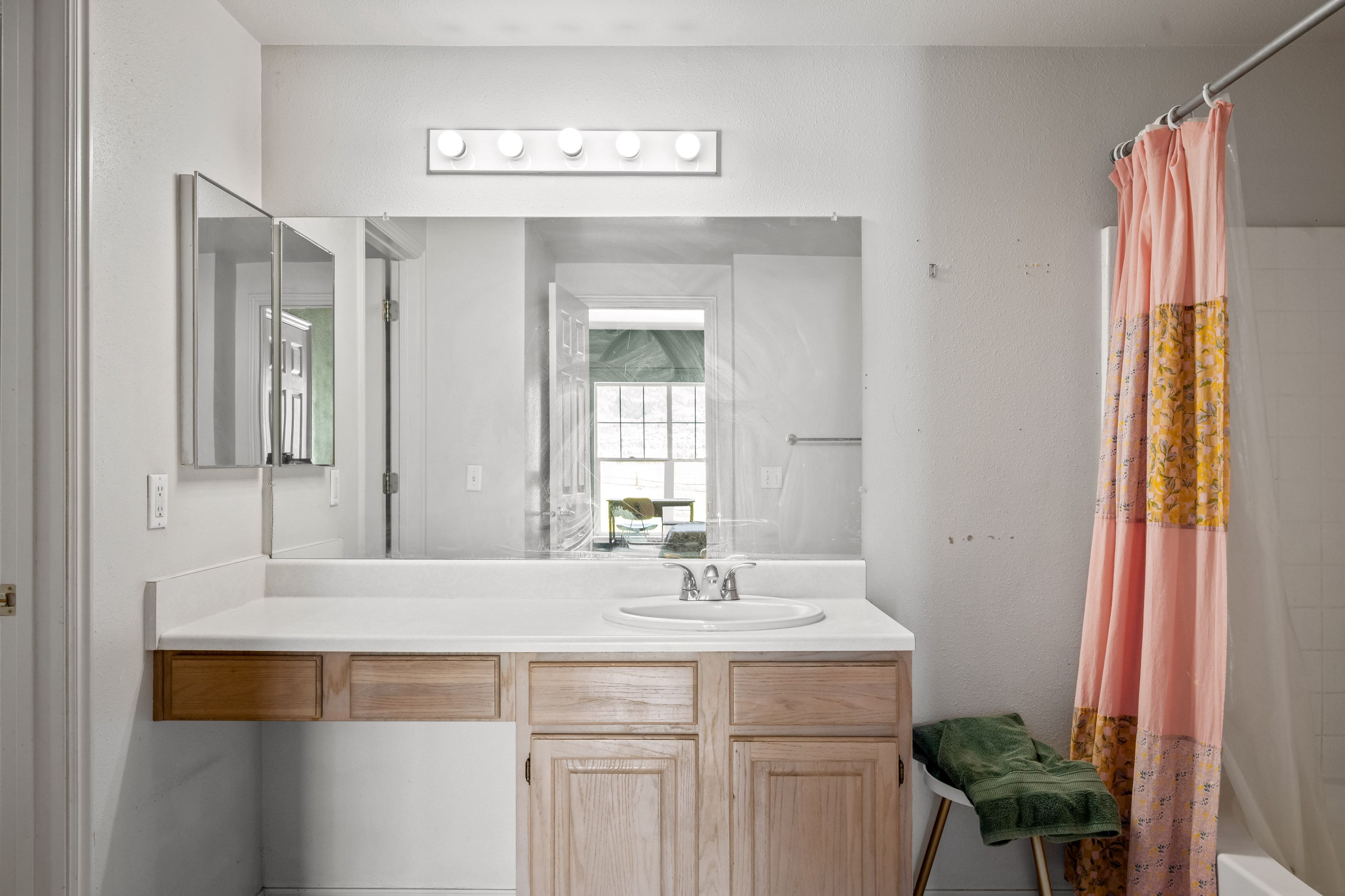 White vanity countertop with an integrated sink and chrome faucet