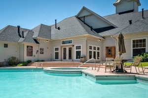 Outdoor swimming pool with integrated spa tub