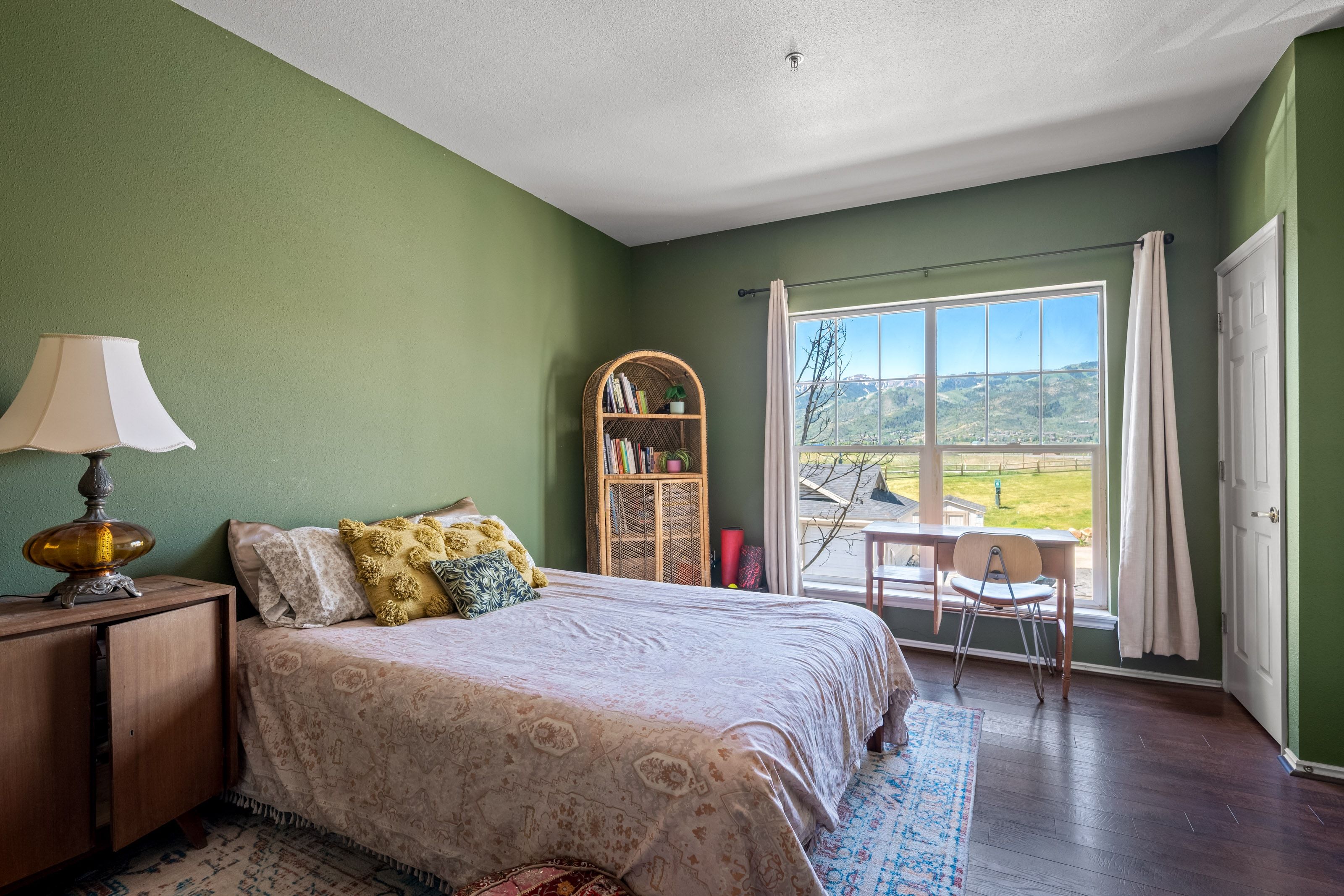 Expansive window featuring distant mountain and field scenery
