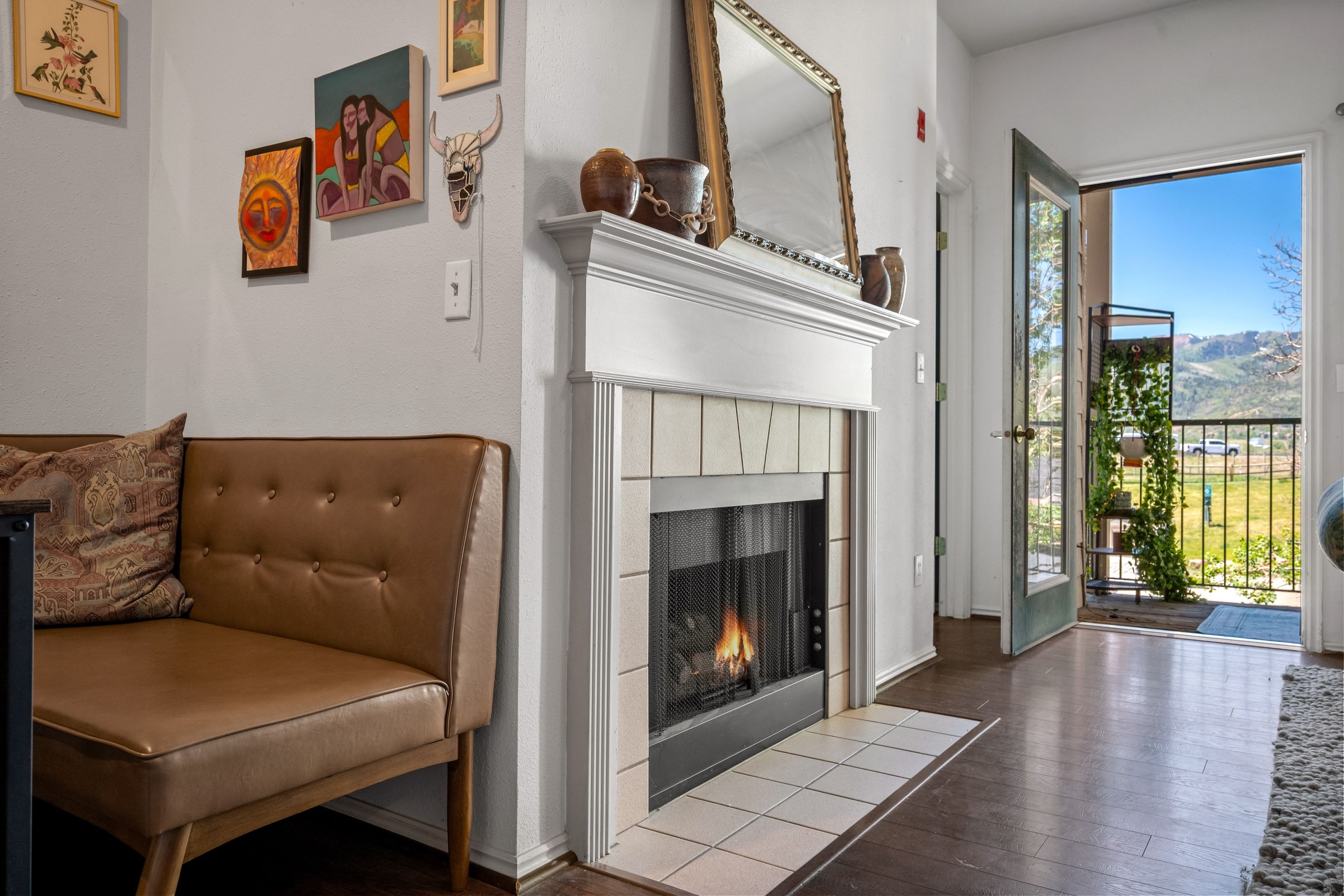 Fireplace featuring a white mantel, hearth with square tile, and dark wood-finish flooring