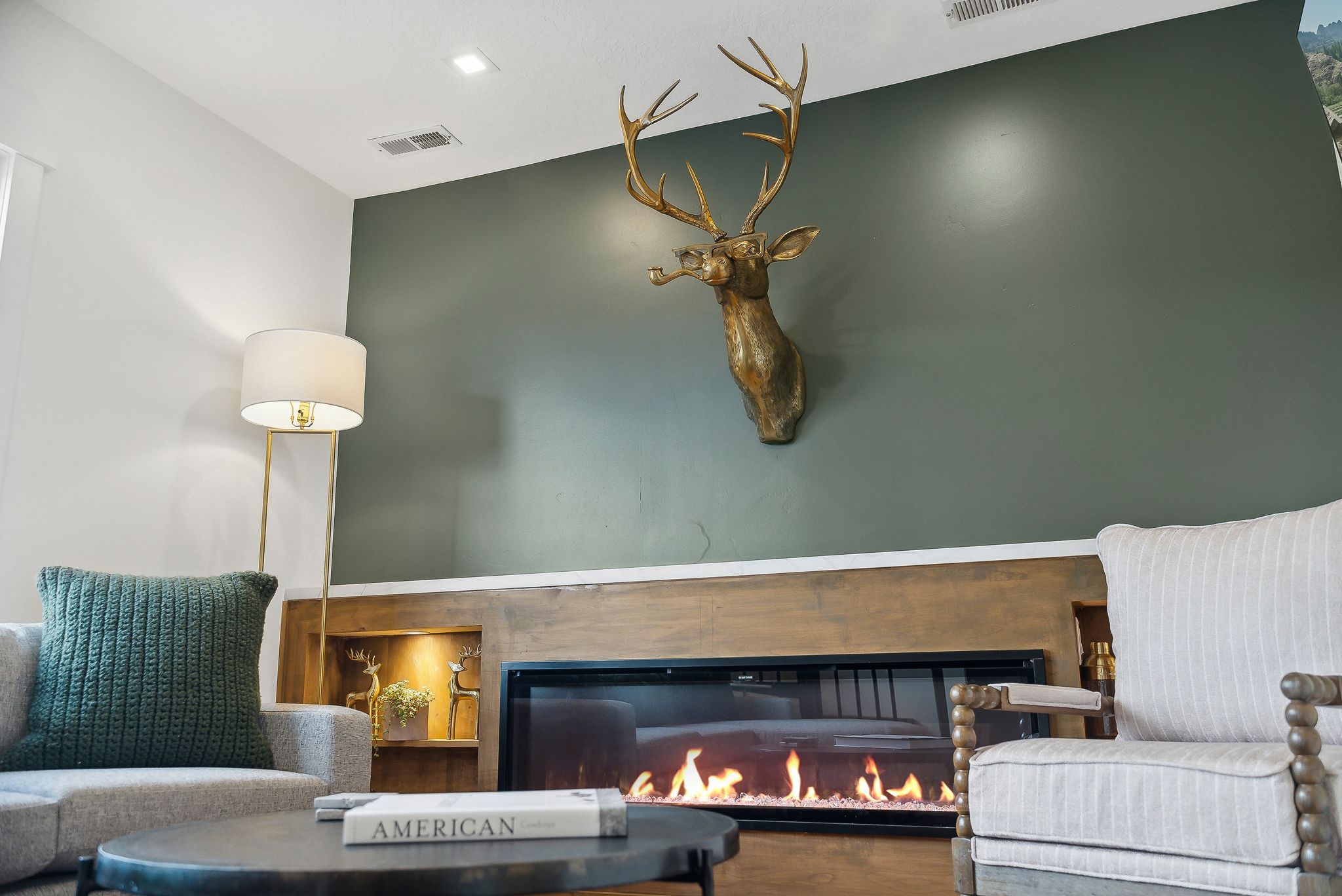 Accent wall with a built-in linear fireplace and wood mantle