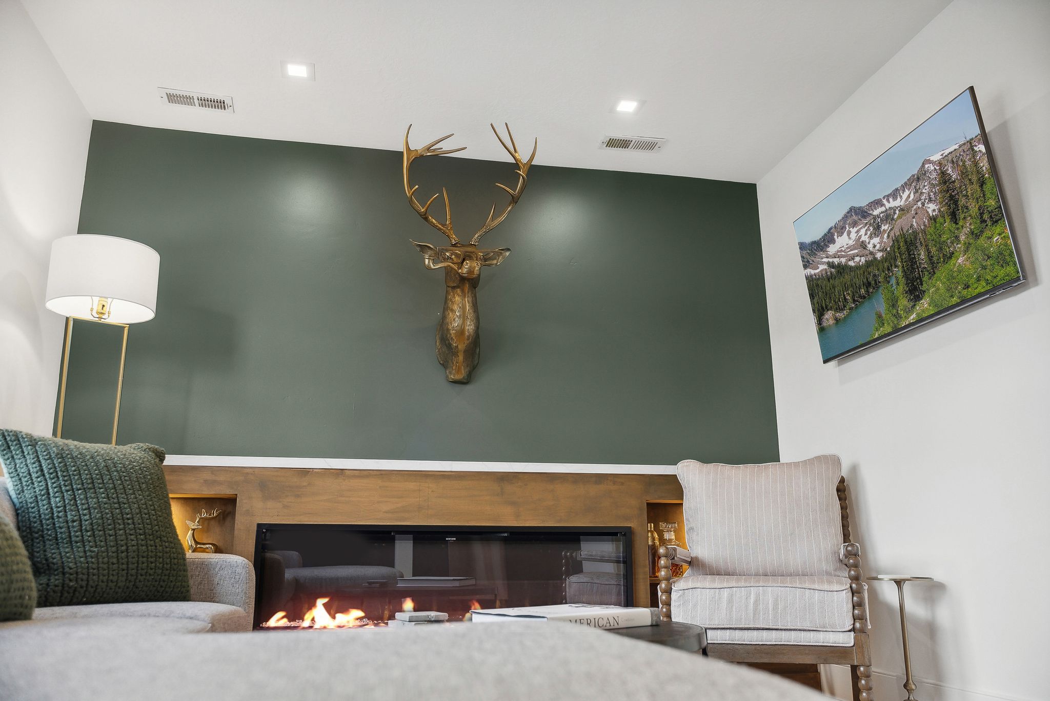 Integrated electric fireplace with wood-finish mantel and built-in shelving