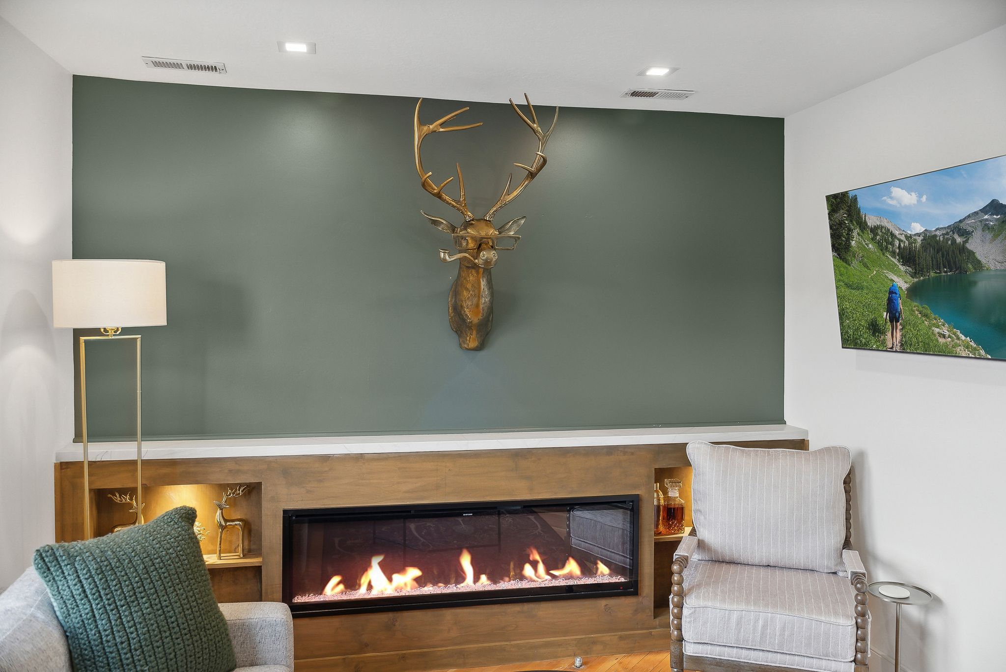 Built-in linear fireplace with a light wood-finish surround and integrated shelving
