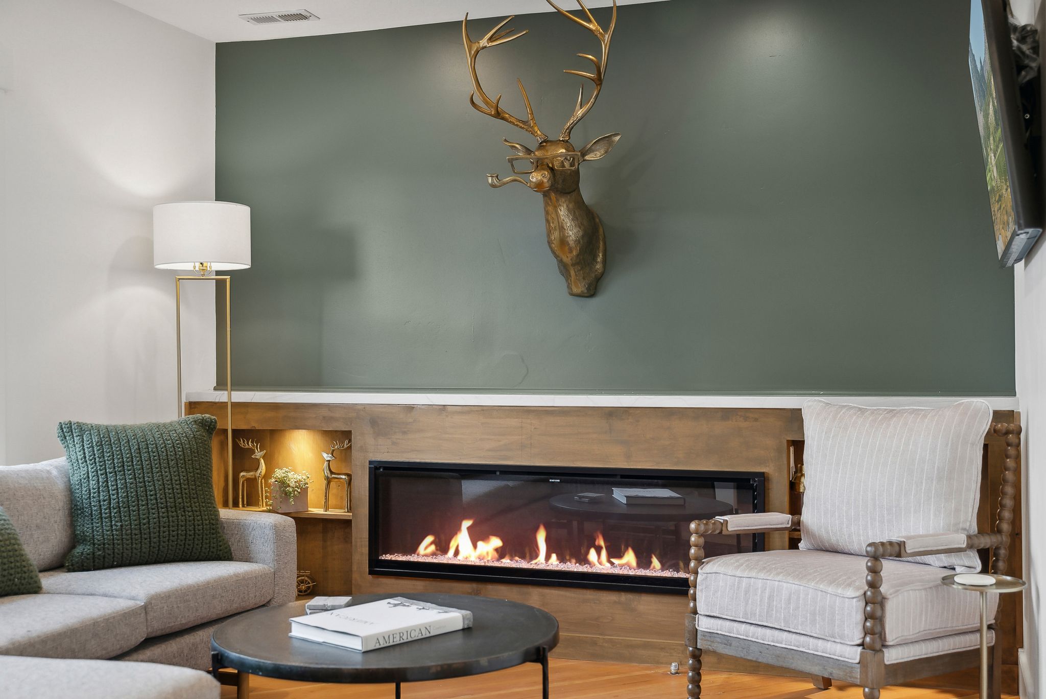Modern linear fireplace with a wood-finish mantel and integrated accent lighting