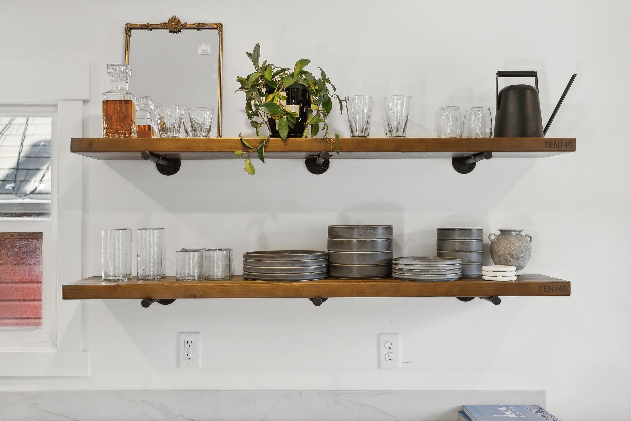 Open shelving with wood-finish planks and industrial-style pipe supports