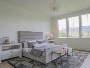 Spacious room featuring light wood-finish flooring and a light-toned area rug