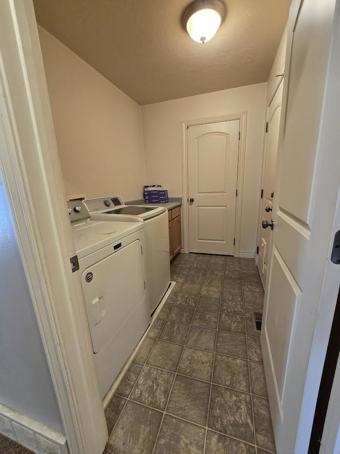 Laundry area featuring tiled flooring, a built-in counter with cabinetry, and an overhead flush mount light fixture