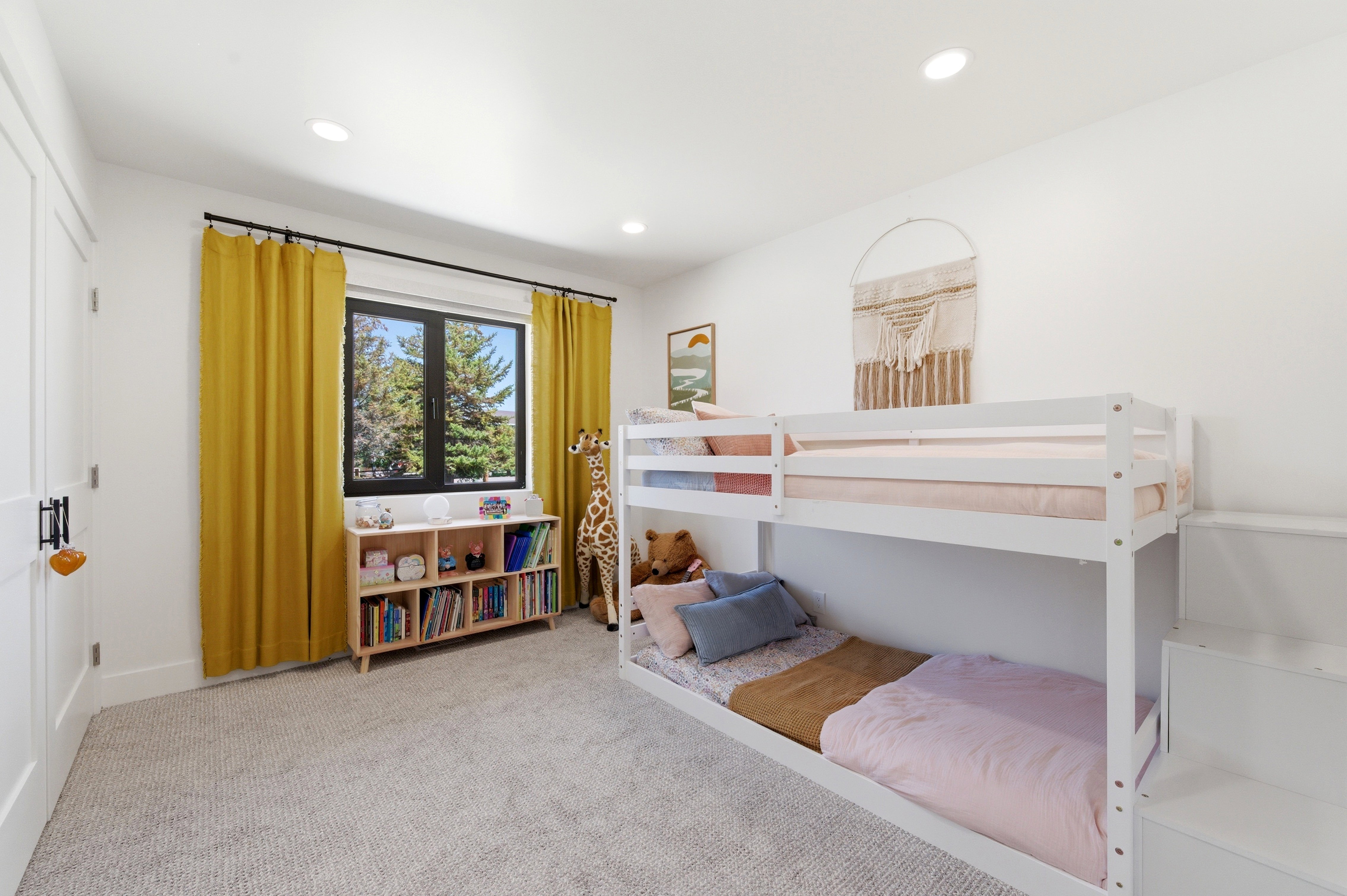 White walls with recessed lighting and light-toned carpeting