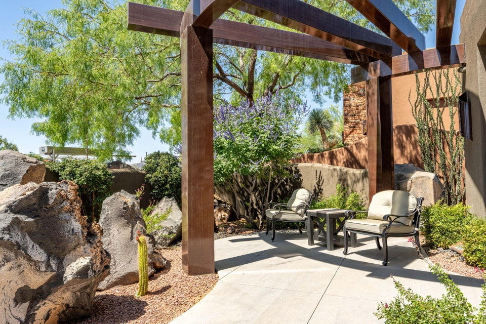 Outdoor patio featuring a contemporary wood pergola and concrete paving
