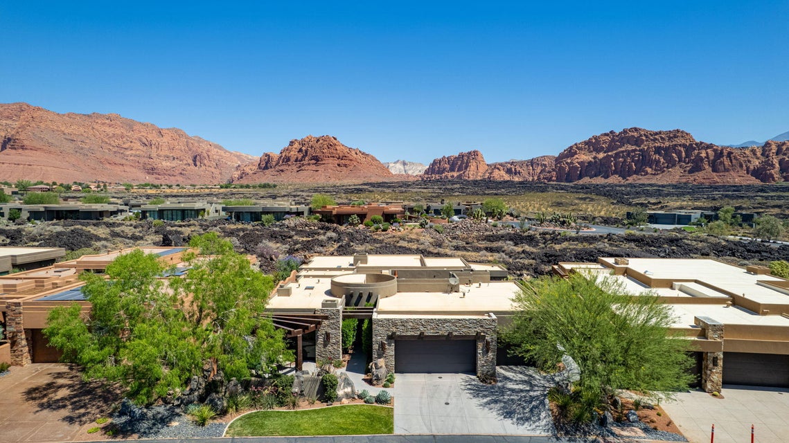 Contemporary desert home featuring a stone facade and a flat roofline