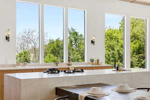 White kitchen with a substantial island featuring a cooktop