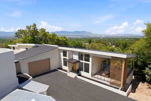 Modern architectural exterior with a flat roofline and integrated garage