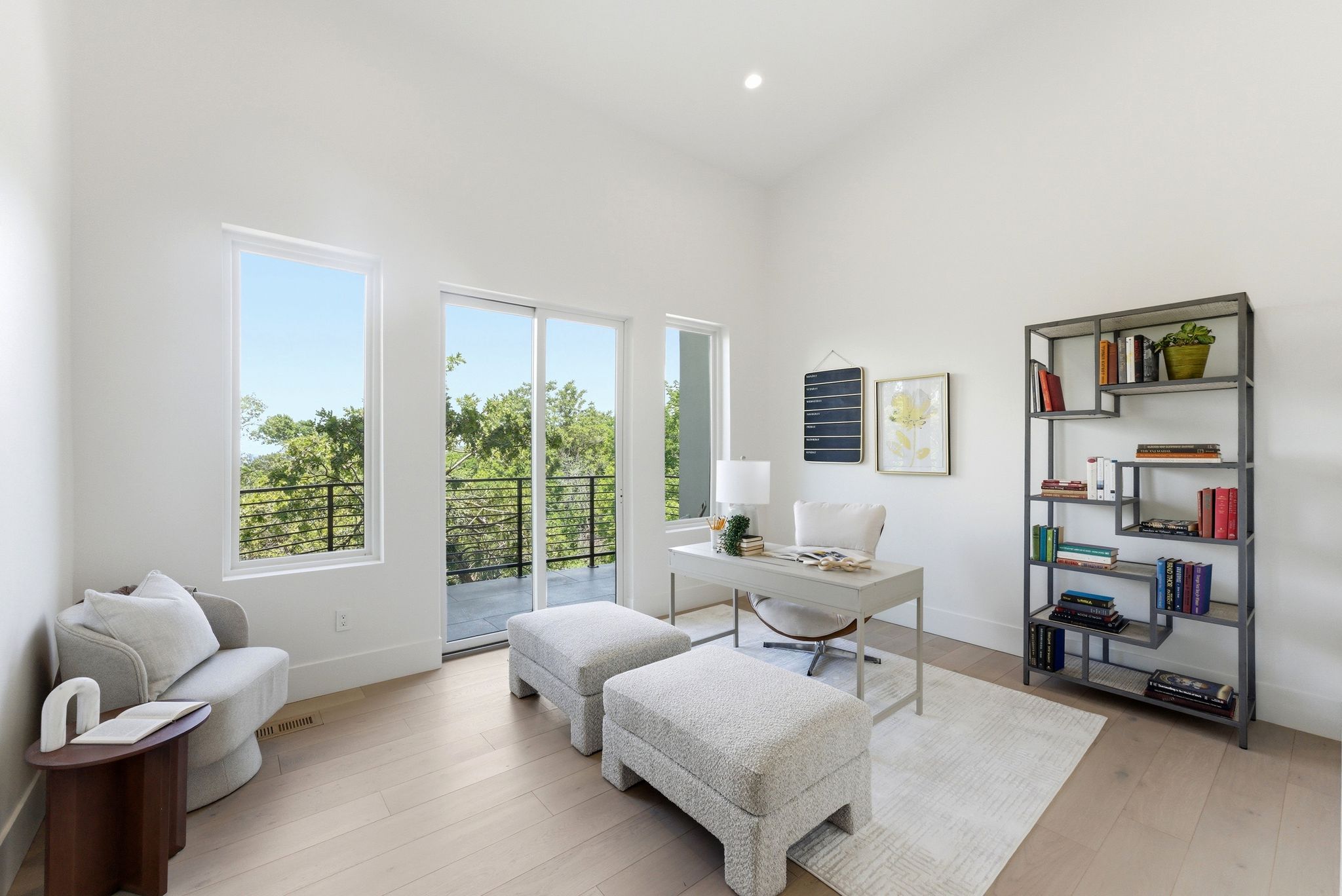 Bright room with large windows and a sliding glass door leading to an outdoor balcony