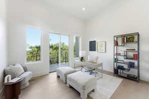 Bright room with large windows and a sliding glass door leading to an outdoor balcony
