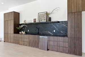 Integrated walnut-finish cabinetry with a built-in dishwasher