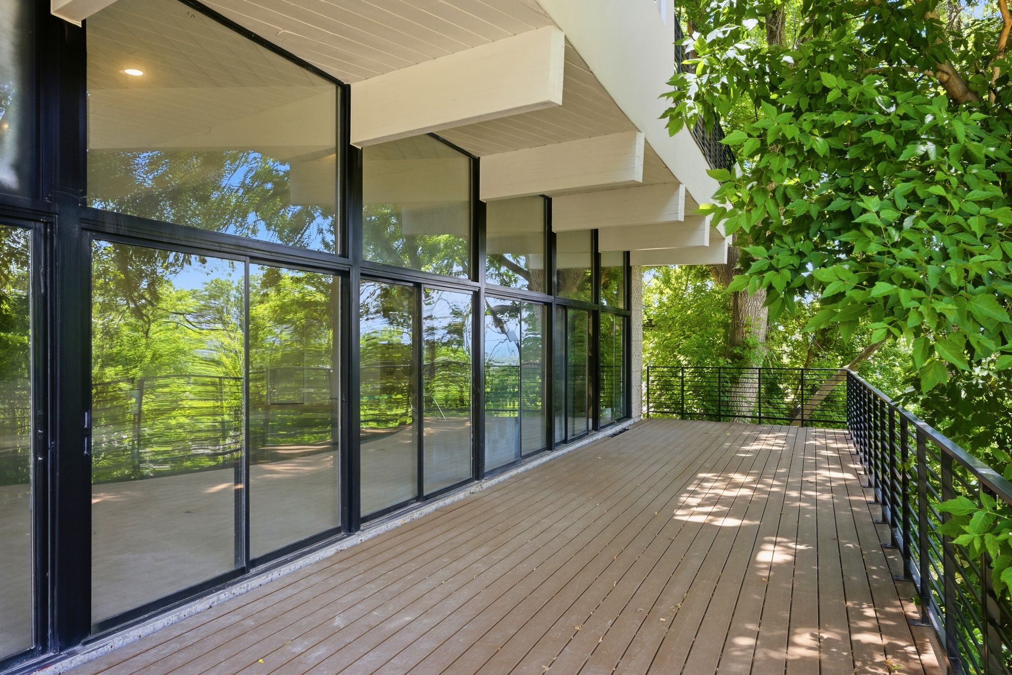 Expansive outdoor deck featuring composite decking and black metal railings