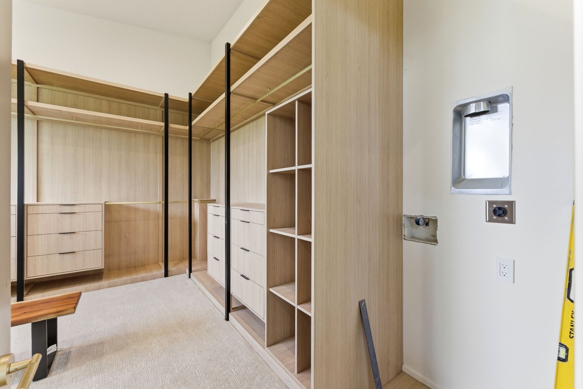 Custom closet system featuring light wood-finish shelving and drawer units, black metal supports, https://utahrealestate.com/lip.wizard/run/step/2/hbid/5433299#and integrated hanging rods