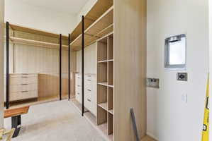 Custom closet system featuring light wood-finish shelving and drawer units, black metal supports, https://utahrealestate.com/lip.wizard/run/step/2/hbid/5433299#and integrated hanging rods