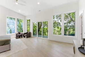 Expansive room featuring vaulted ceilings, recessed lighting, and wood-finish flooring