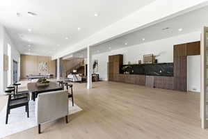 Expansive open-concept living space with light wood-finish flooring