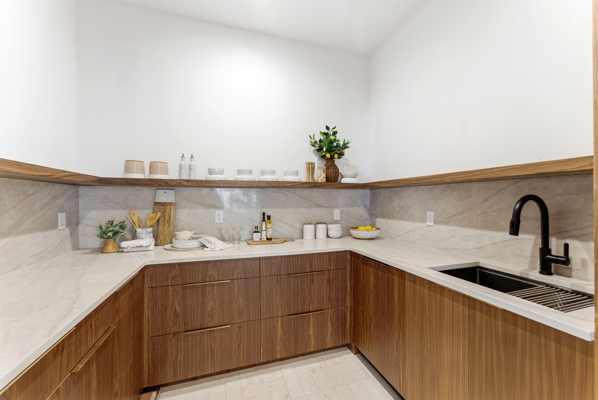 U-shaped kitchen counter with wood-finish cabinetry and light-toned countertops