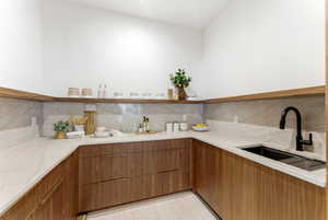 U-shaped kitchen counter with wood-finish cabinetry and light-toned countertops