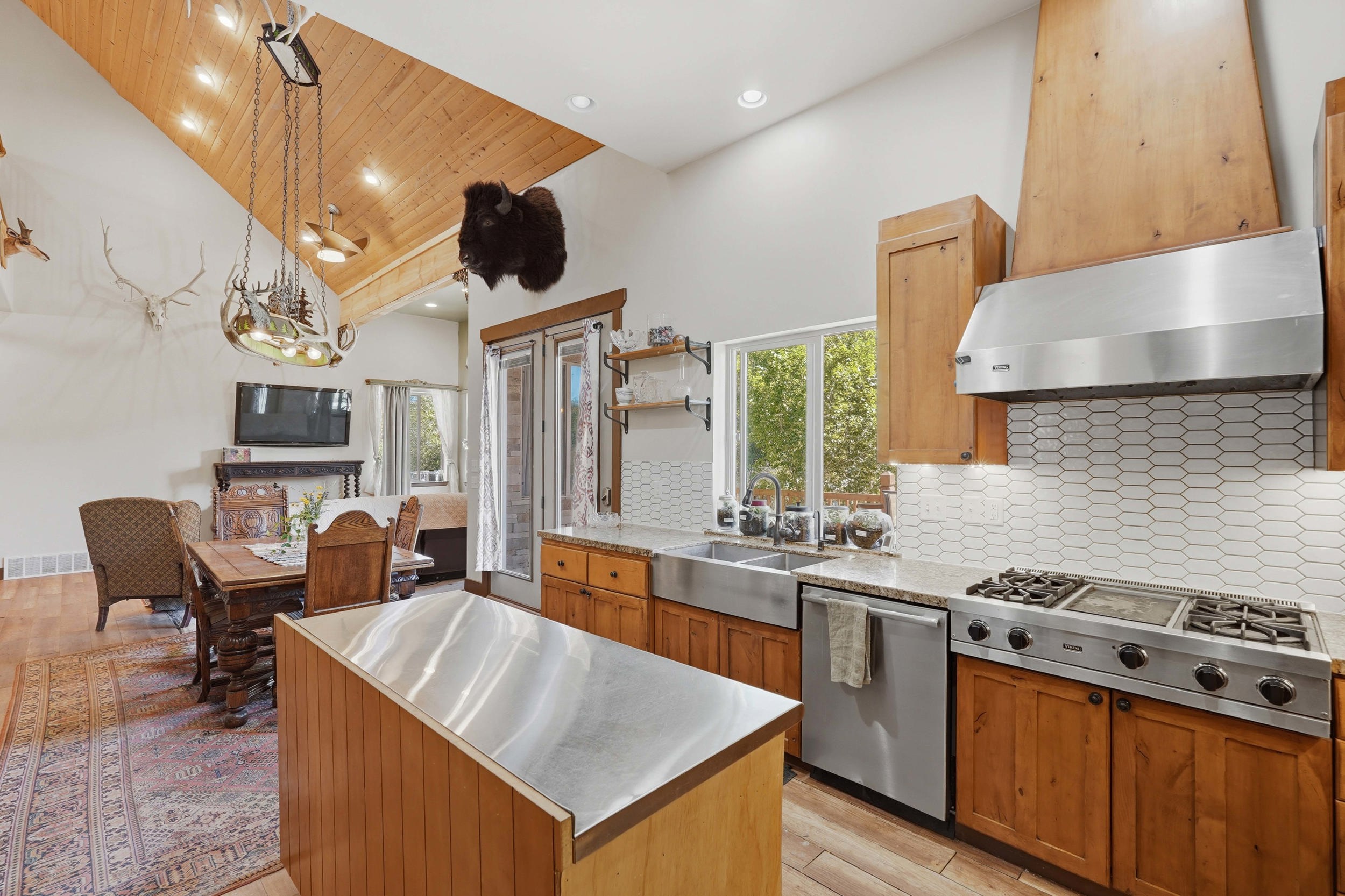 Spacious kitchen featuring wood-finish cabinetry, stainless steel appliances, and a farmhouse sink