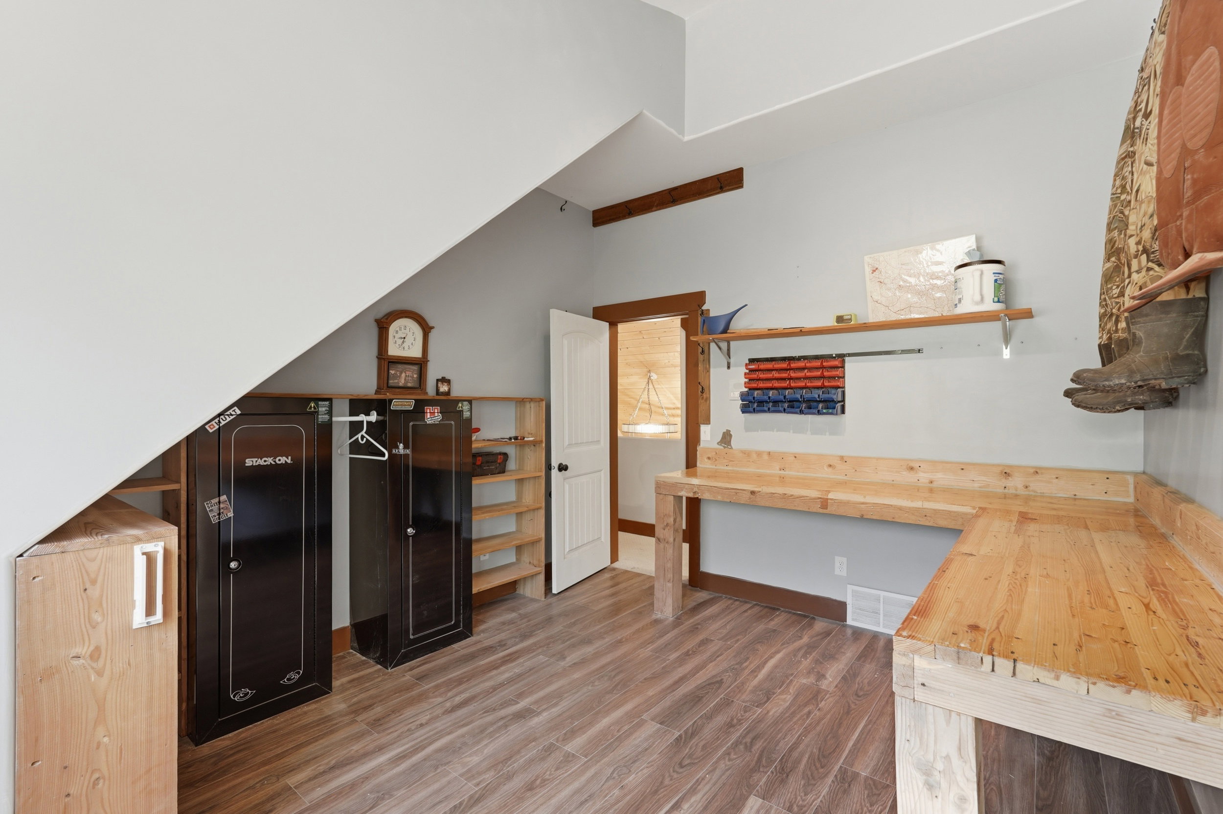 Versatile space featuring wood-finish flooring and a built-in wooden workbench