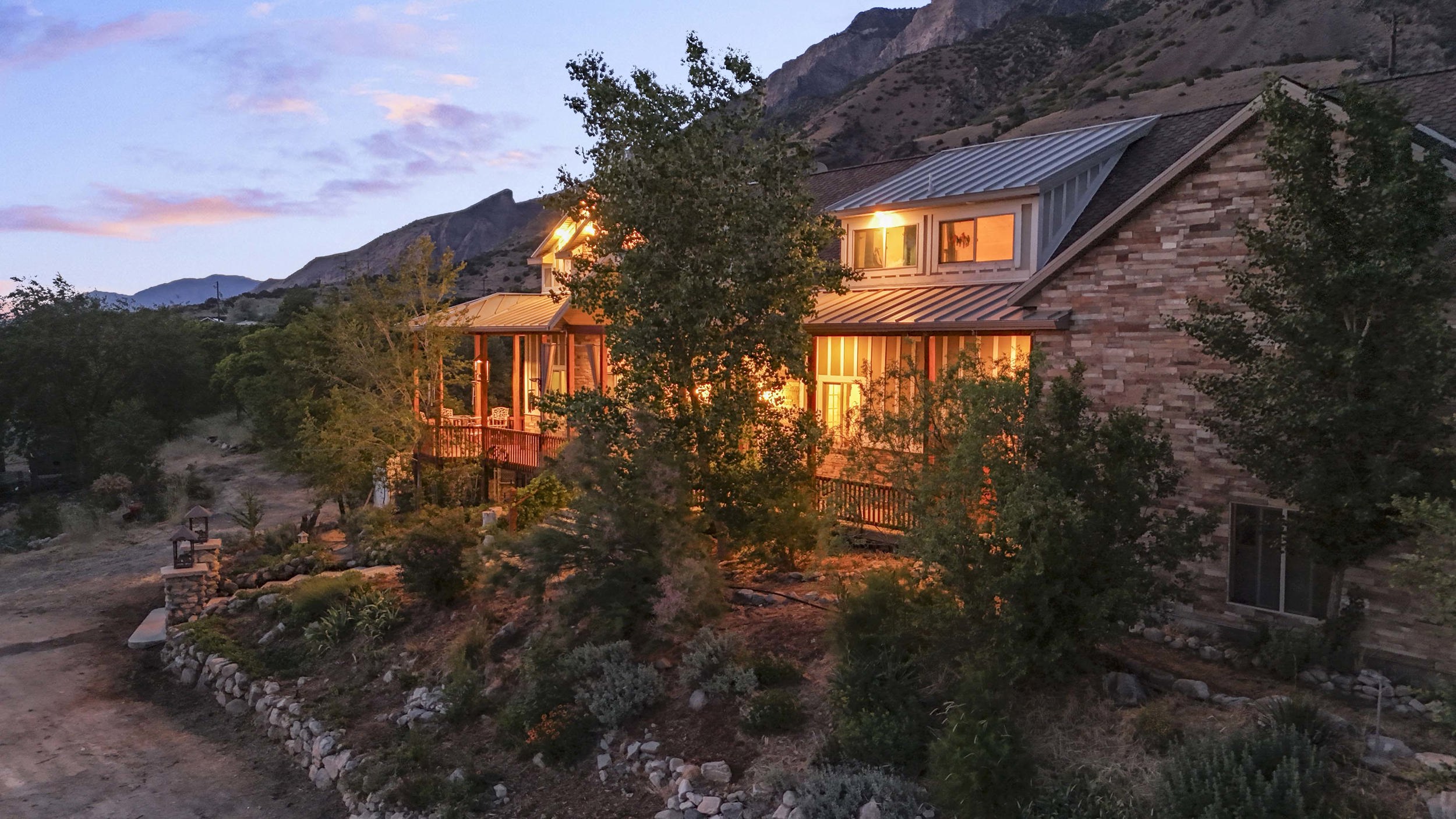 Stone exterior featuring a corrugated metal roof and multiple dormer windows