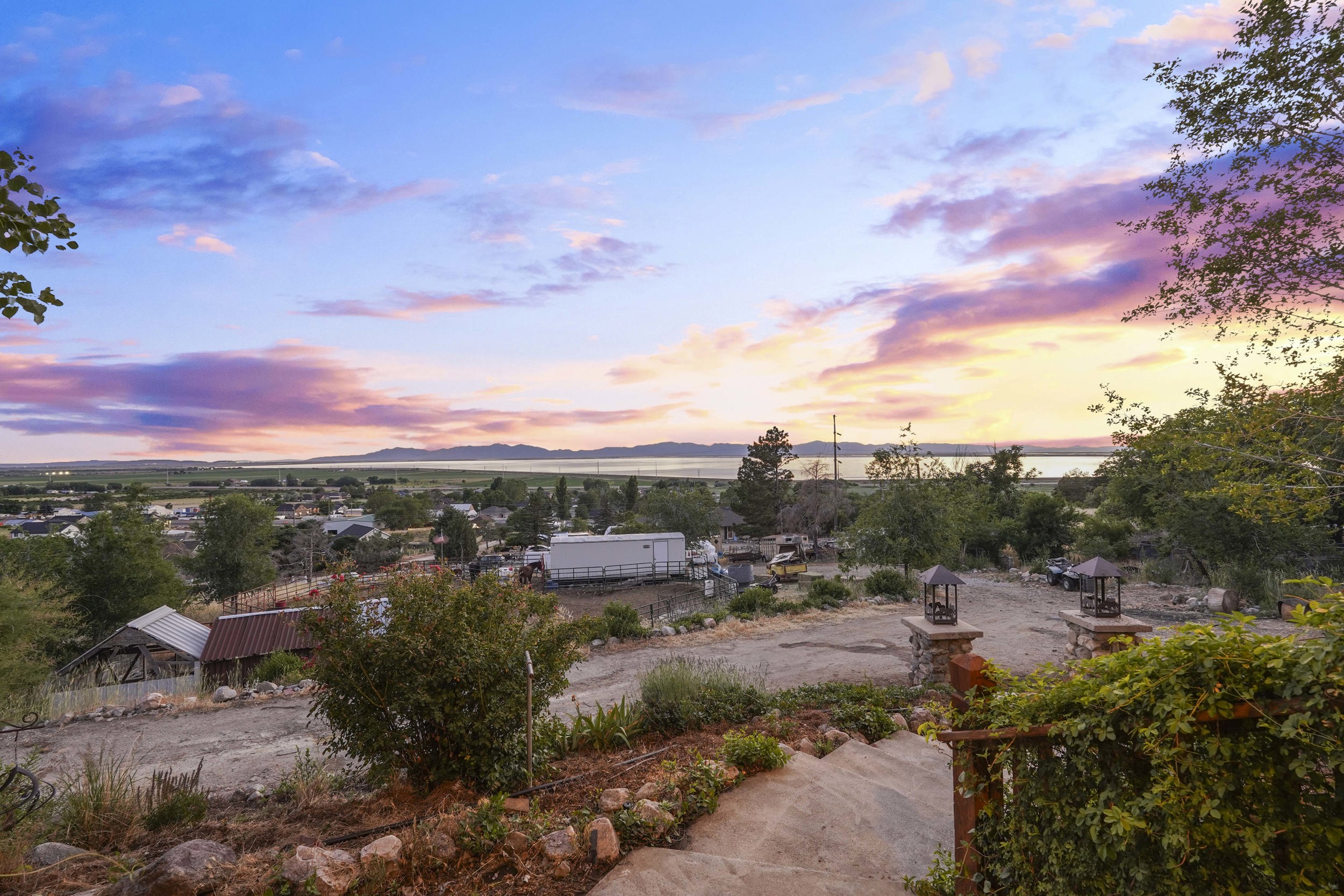 Expansive landscape with distant body of water and mountain range