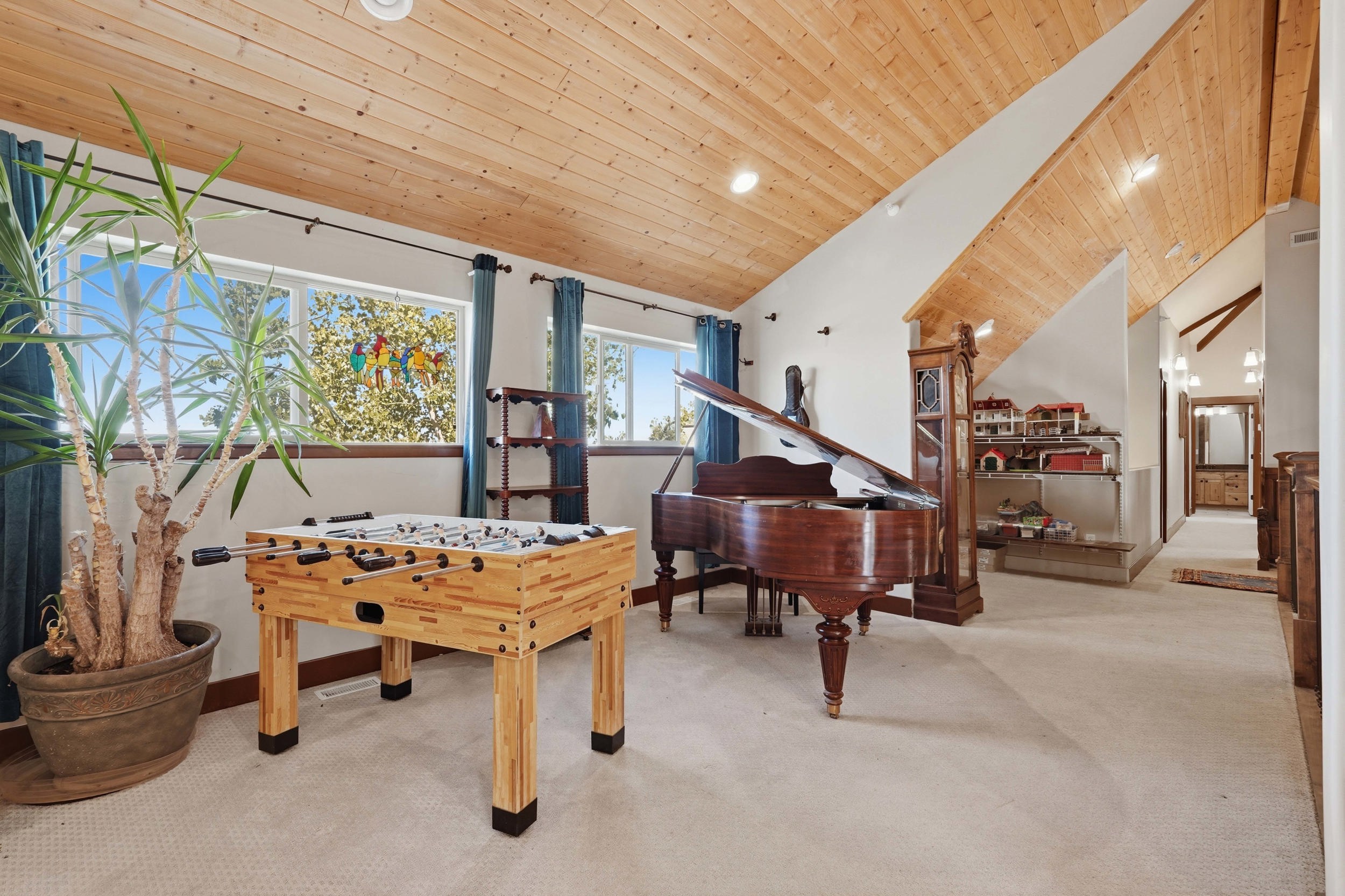 Vaulted wood-paneled ceilings over light-toned carpeting