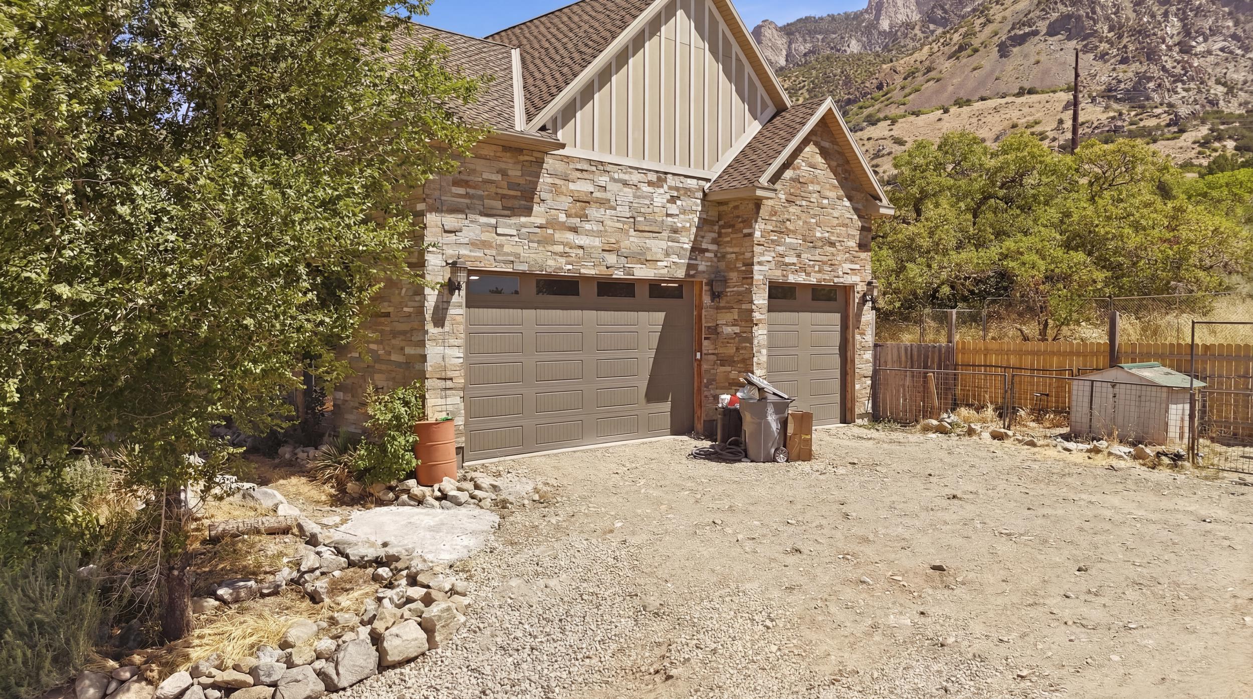 Three car garage with panel-style doors and upper window accents