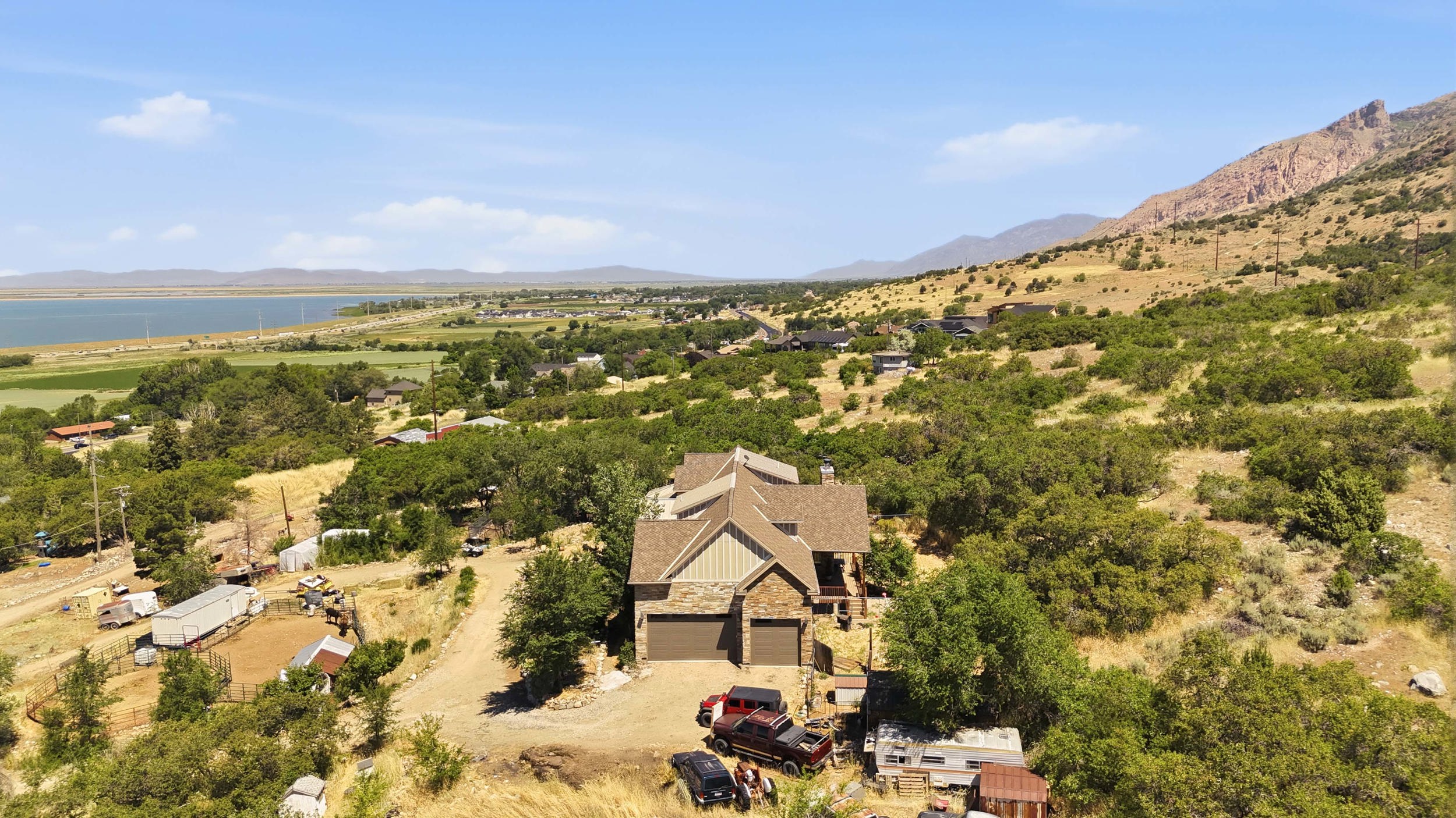 Craftsman-style home featuring a prominent two-car garage, stone and siding exterior, and a multi-level roofline